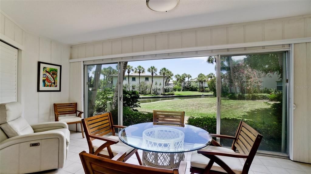 YOUR BEAUTIFUL VIEW FROM THE LANAI . OWNER RECENTLY HAD CUSTOM SHADES INSTALLED ON THESLIDING DOORS. FACING EAST, IT'S A LOVELY SPOT FOR A MORNING CUP OF COFFEE.