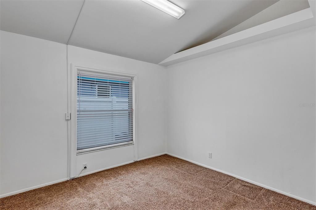 Carpeted bedroom #3 (was a craft room -hence industrial light)