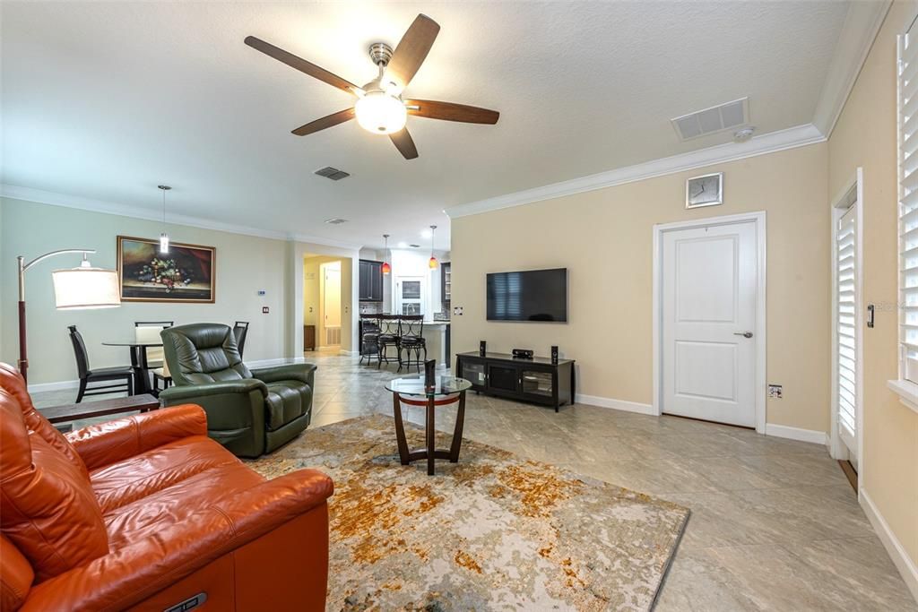 The solid white door leads to the primary bedroom with ensuite bath, which is separate from all the other bedrooms. The door to the right of that leads out to the enclosed porch and the second screened porch beyond.