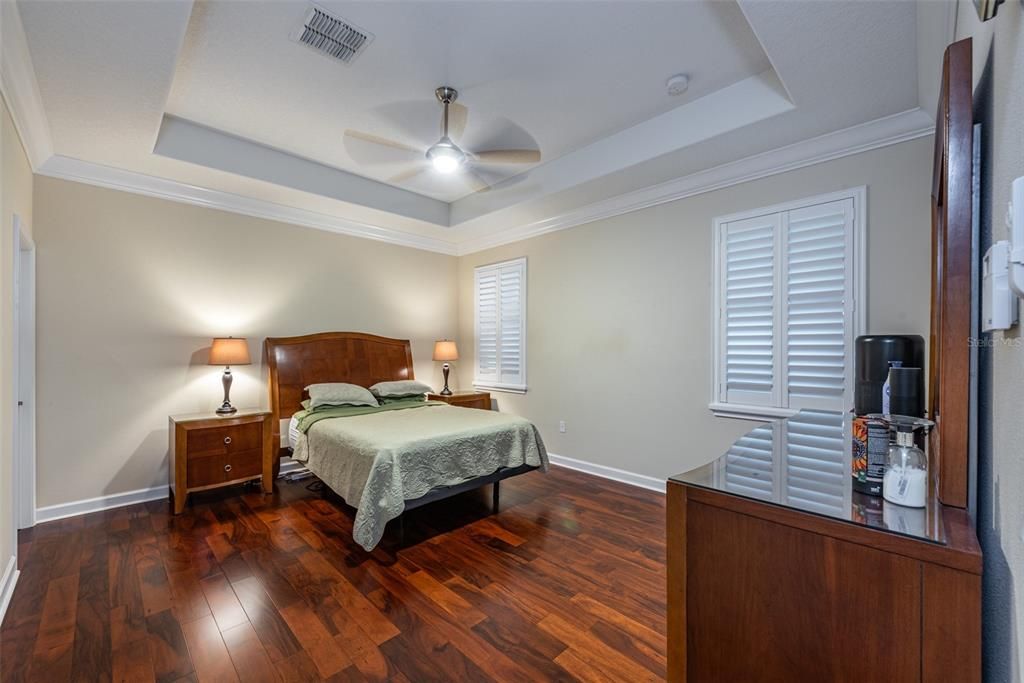 The tray ceiling makes this primary bedroom feel even larger. It is located at the back of the house and with no backyard neighbors is a lovely retreat. The flooring is engineered hard wood.