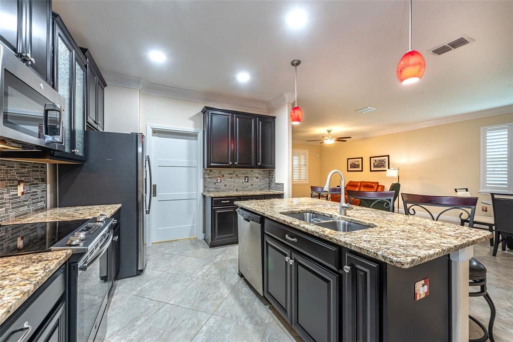 Notice the barn style sliding door next to the refrigerator.  That leads to the laundry room, how convenient!