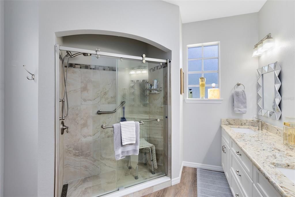 Owner's bathroom has been smartly updated with a walk-in shower and updated counters
