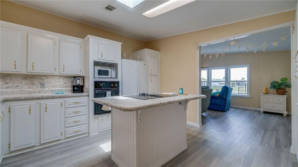 The kitchen, the heart of the home, is perfectly positioned. Steps from the dining area. Steps from the lakefront family room.