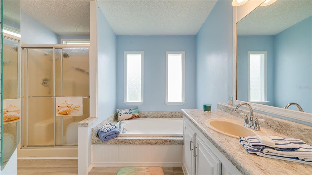 A stand alone shower, a soaking tub, beautiful counter tops, and additional storage!