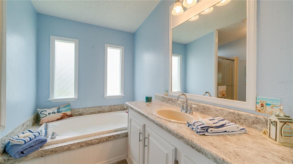 A stand alone shower, a soaking tub, beautiful counter tops, and additional storage!