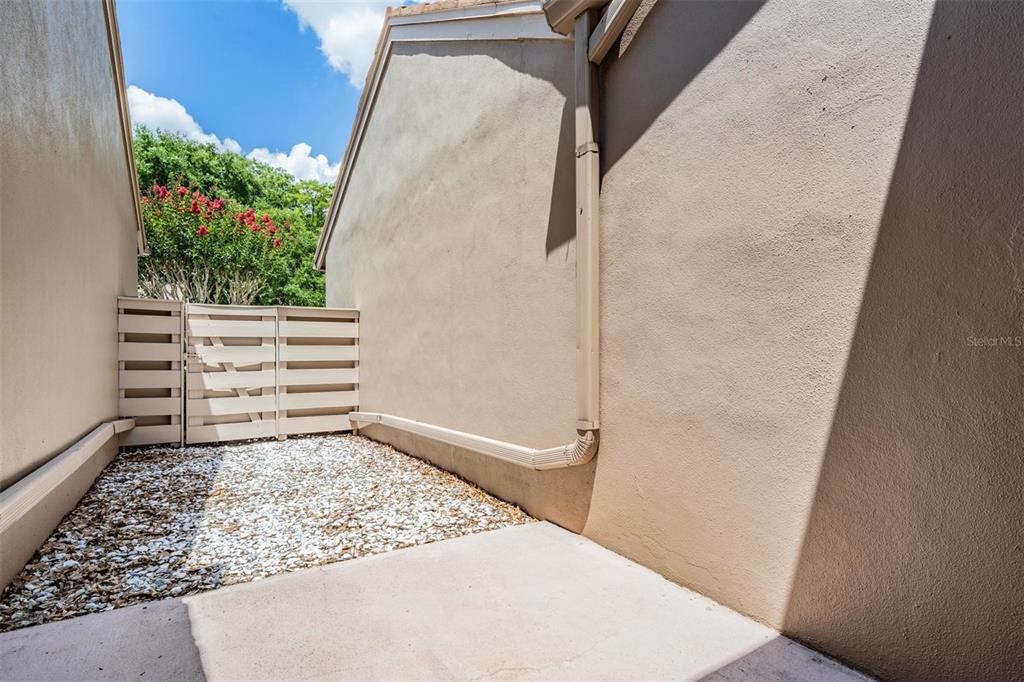 Courtyard off kitchen with gate to front of villa