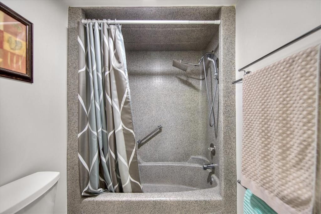 Tub/shower combo in the bathroom.