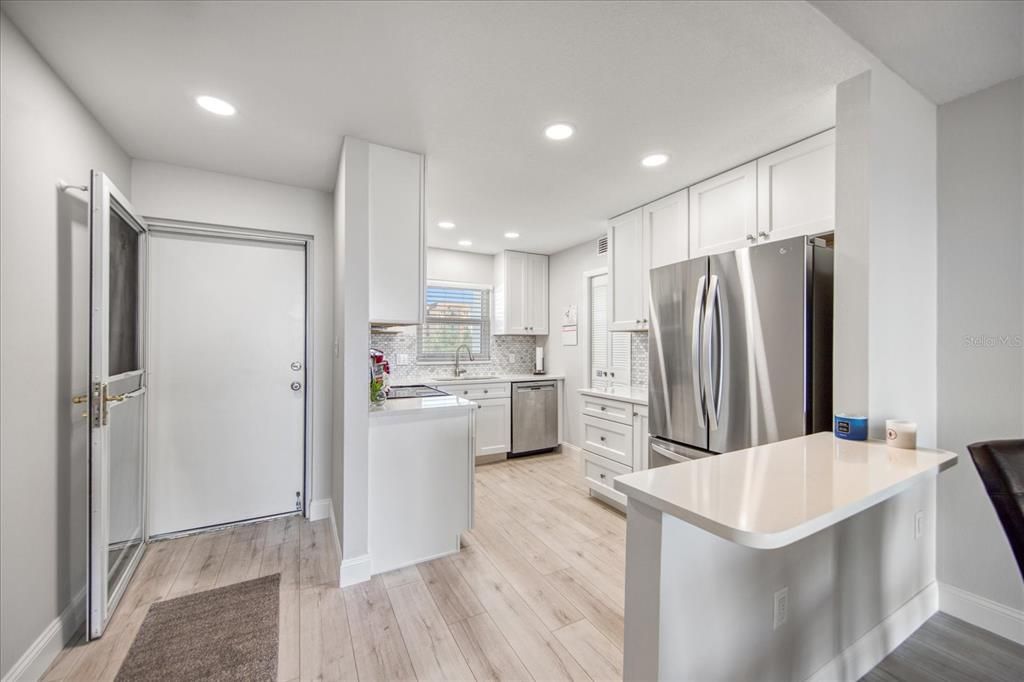 Entrance into this beautifully remodeled 4th floor condo with the gorgeous open kitchen at the front.