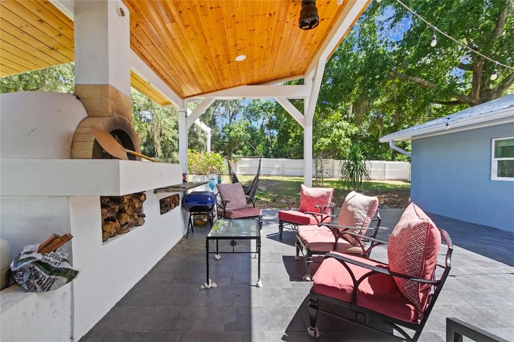 Large patio with pizza oven and granite counters