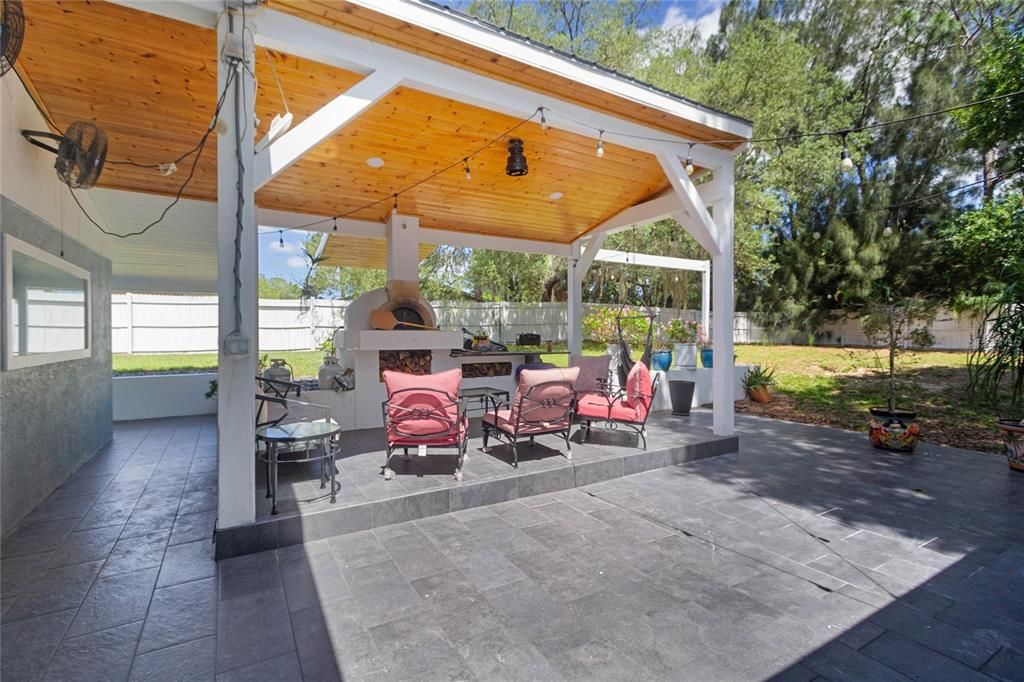 Large patio with pizza oven and granite counters