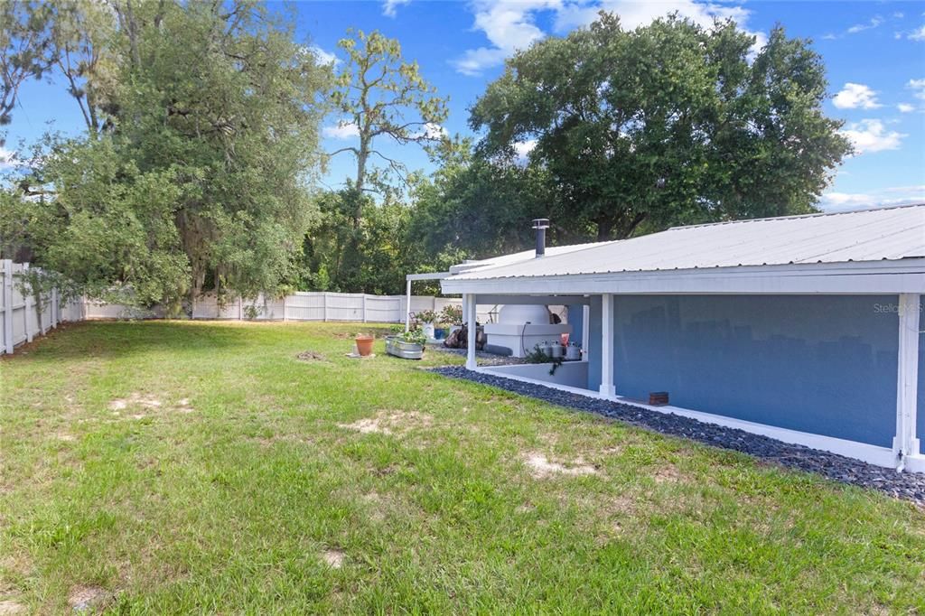 Fenced area of yard and back patio area.