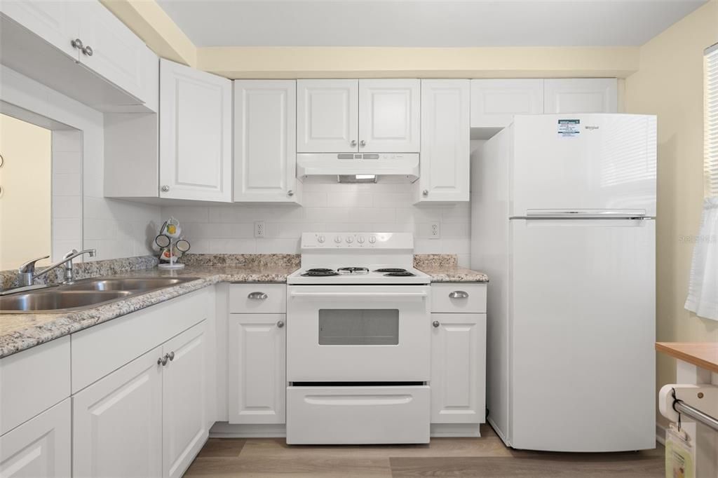 The kitchen features tons of storage and a convenient pass-through to the dining room.