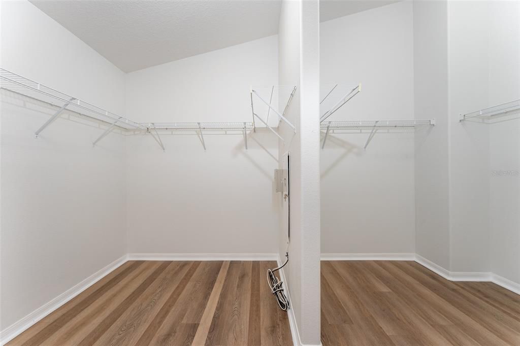 large walk-in closet with divider for the Primary bedroom