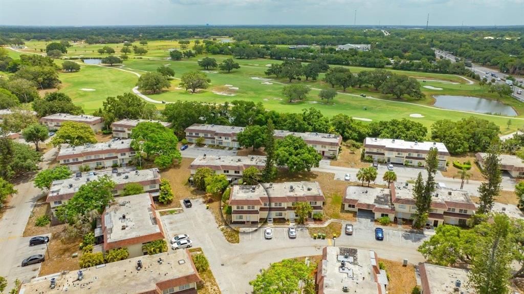 Front Elevation of the building/unit and the surrounding area. Shows the Bobby Jones 27- Hole Golf Course in the back.