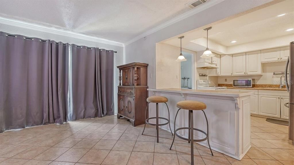 Living Room/Great Room featuring sliding glass doors to the back lanai, and access to the kitchen.