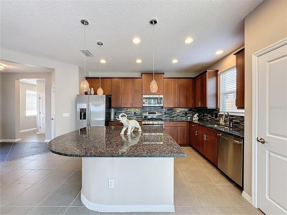 Oversized island for food prep and seating, upgraded cabinets, faucets and hardware