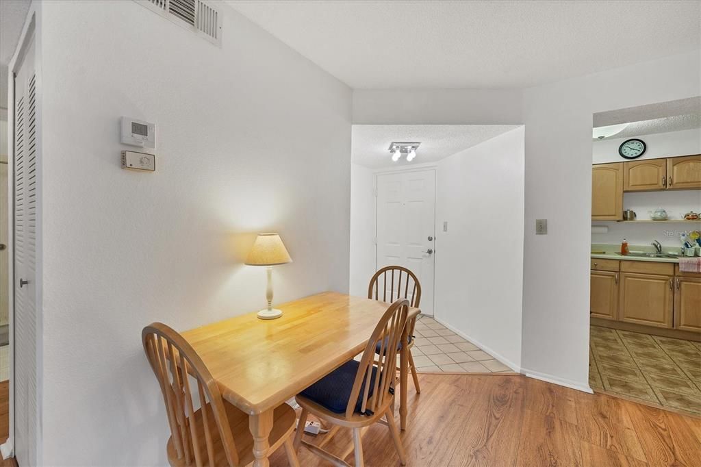 Interior foyer at rear of photo kitchen to right and dinette area foreground