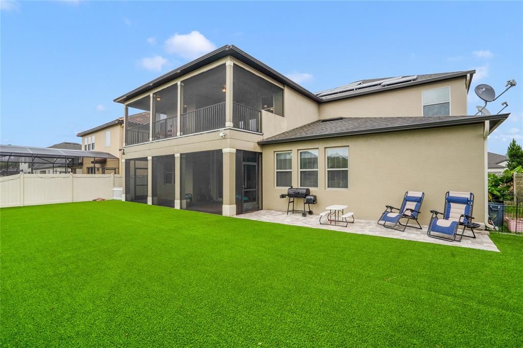 turfed grass with screen enclosed upper and lower patio