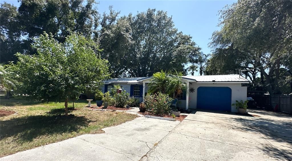 Wide and extended driveway in front of this pool home!