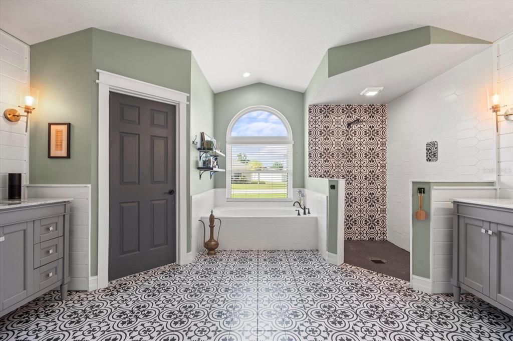 Beautiful tile in Master Bathroom, with his and hers vanities, soaker garden tub and a massive shower.