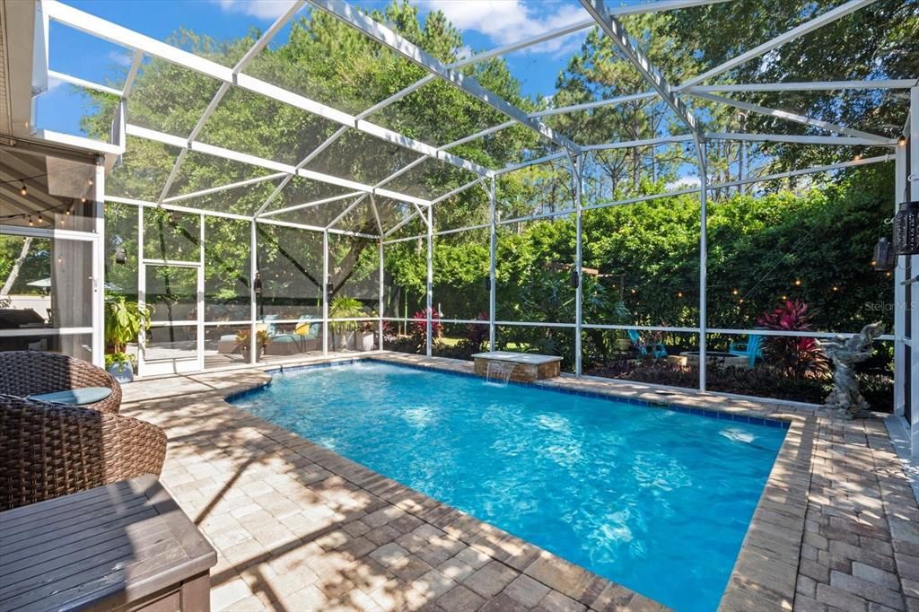 Solar heated saltwater pool with waterfall and sitting ledge.