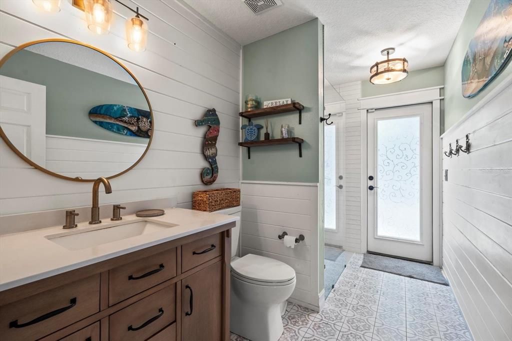 Pool bathroom also remodeled with gorgeous tile and shiplap detailing.