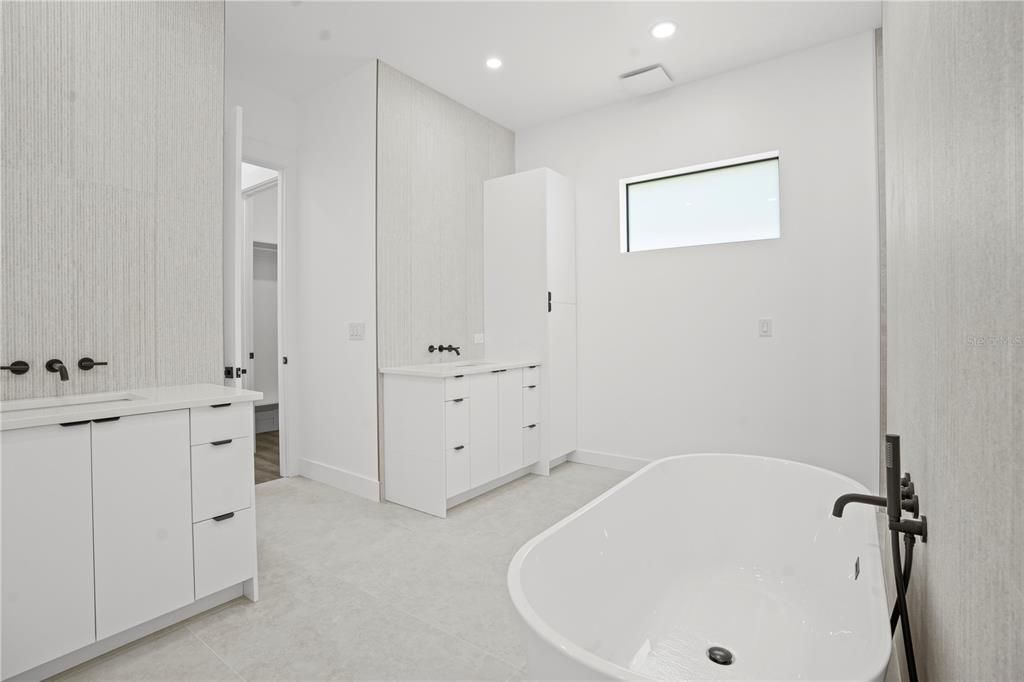 primary bathroom with separate two vanities