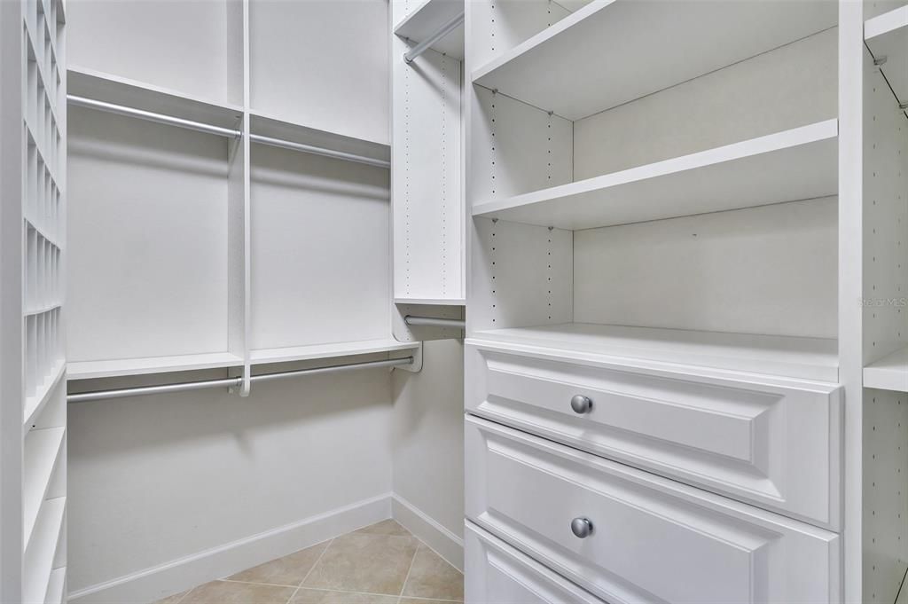 Walk-in closet with custom built-ins in the primary bedroom