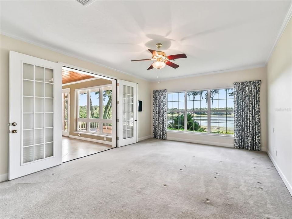 View of main bedroom looking toward back of home.  Note the picture window showing the beautiful lake view.