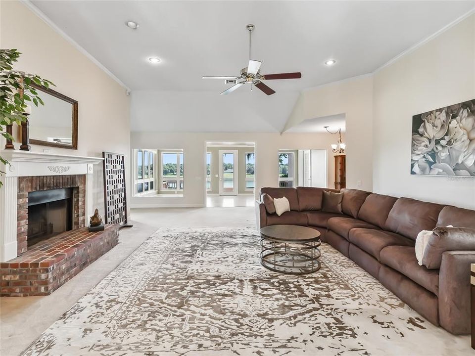 View of living room looking toward back of home.  Note the 12' ceiling and recessed lighting