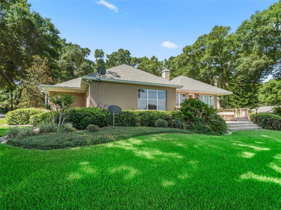 Close view of back right of property.  Note once again the setting with mature, manicured landscaping and framing of trees