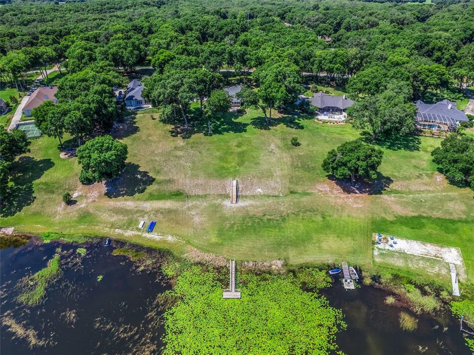 Aerial view of property looking from lake to street