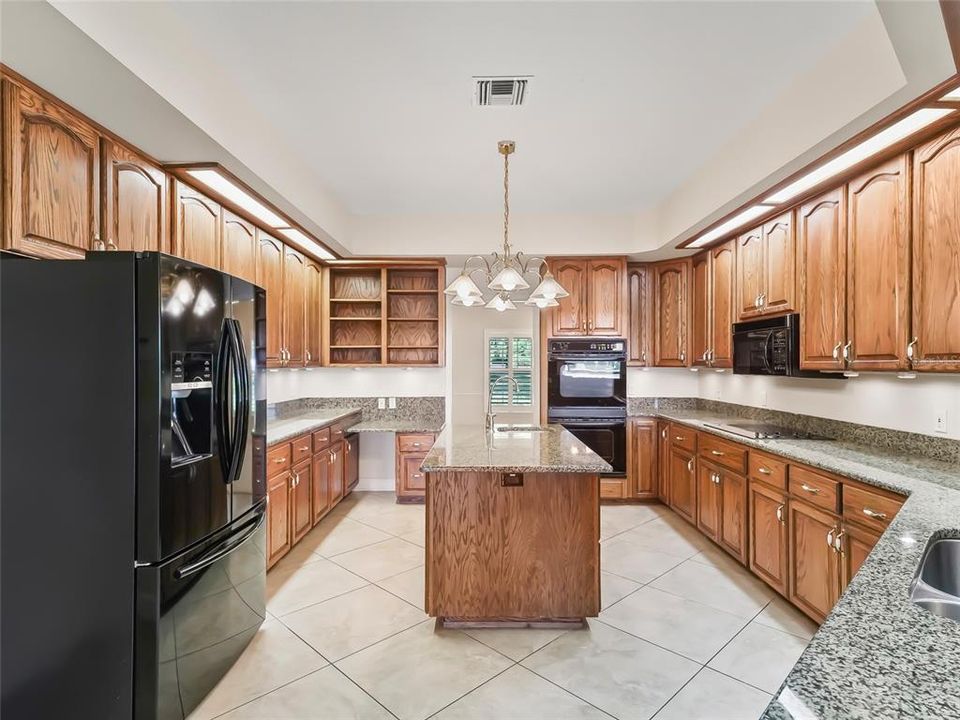 Kitchen looking toward front of home and dining room. Note the center island with second sink.