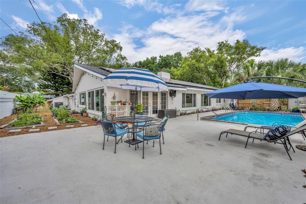 Large patio area adjacent to pool