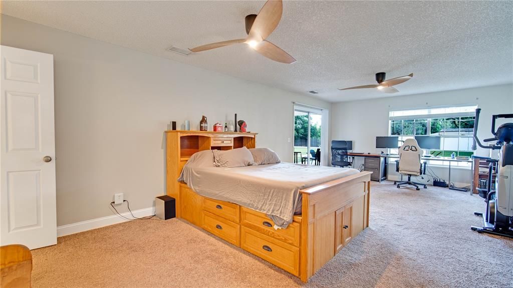 Master Bedroom w/ screened door connects to lanai/backyard