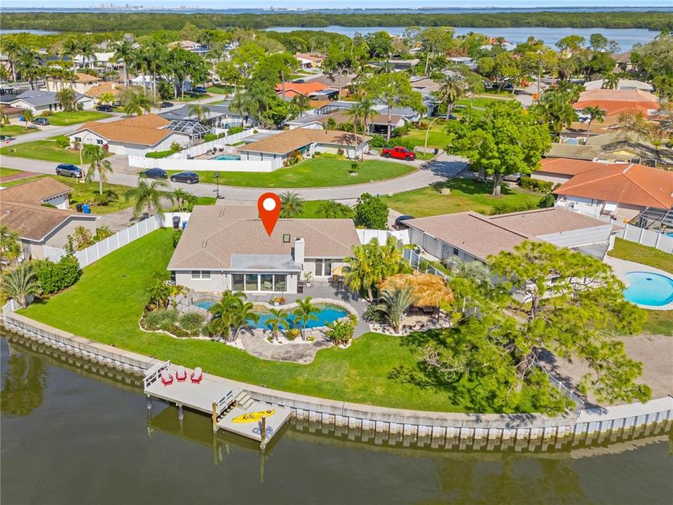 150'+ of seawall. 2 composite docks and direct access to the Bay! Backyard boasts large backyard (over 1/4 of an acre), large pool and spa, and tiki hut!