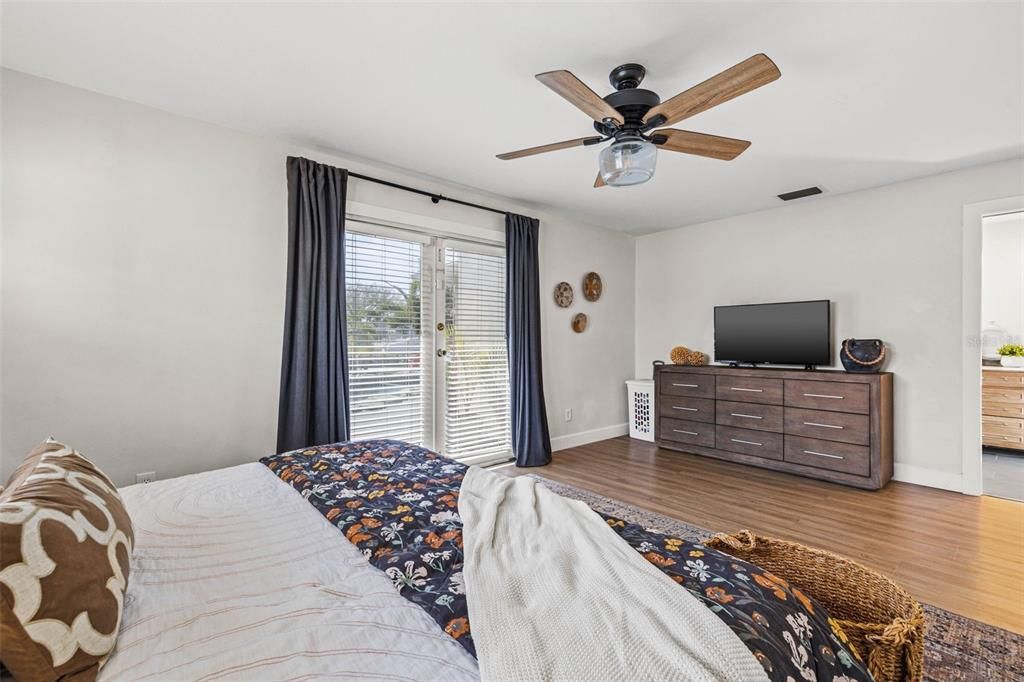 Primary Bedroom with French Doors to Back Patio/ Pool area and Waterfront Views from your Bed!