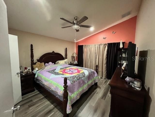 Master Suite with a large window, new flooring and ceiling fan