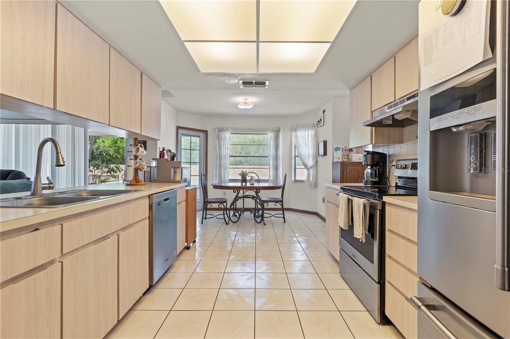 Another view of kitchen, you can see dining area and a door leading to lanai