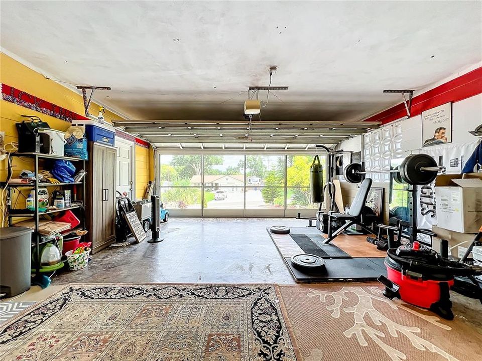 2 car garage w/slide screen doors, stamped concrete, 2 doors to house, 1 door to laundry room that leads to back yard