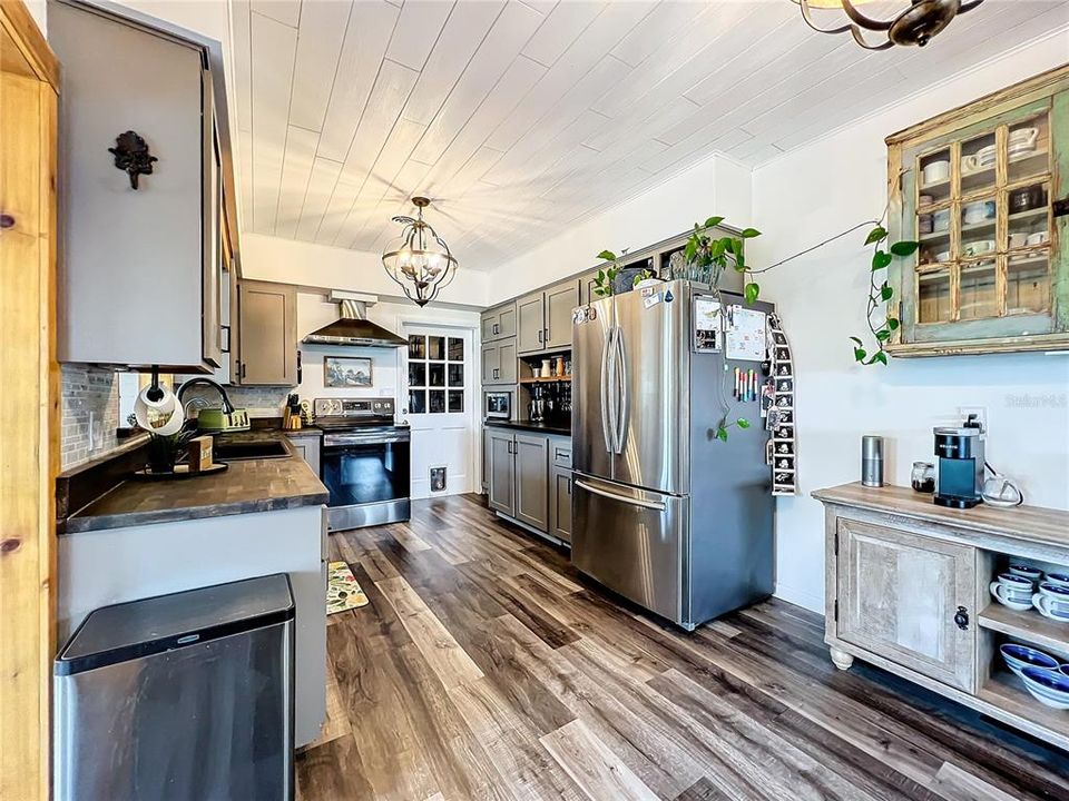 Large Galley Kitchen with Plank Ceiling