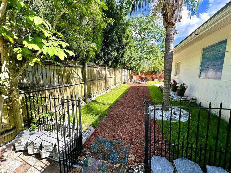 Side yard entrance walkway to fire pit & back yard