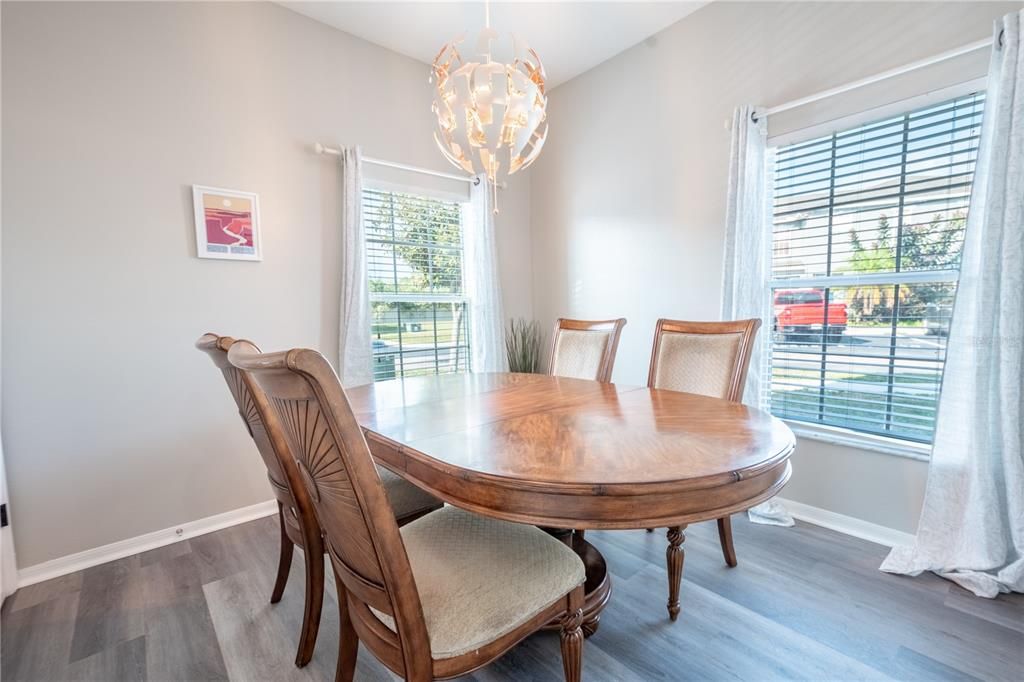 The 10x10 first floor bedroom currently serves as an elegant dining room, featuring a stunning artistic chandelier, wood laminate flooring and 2 large windows adding plenty of natural light.
