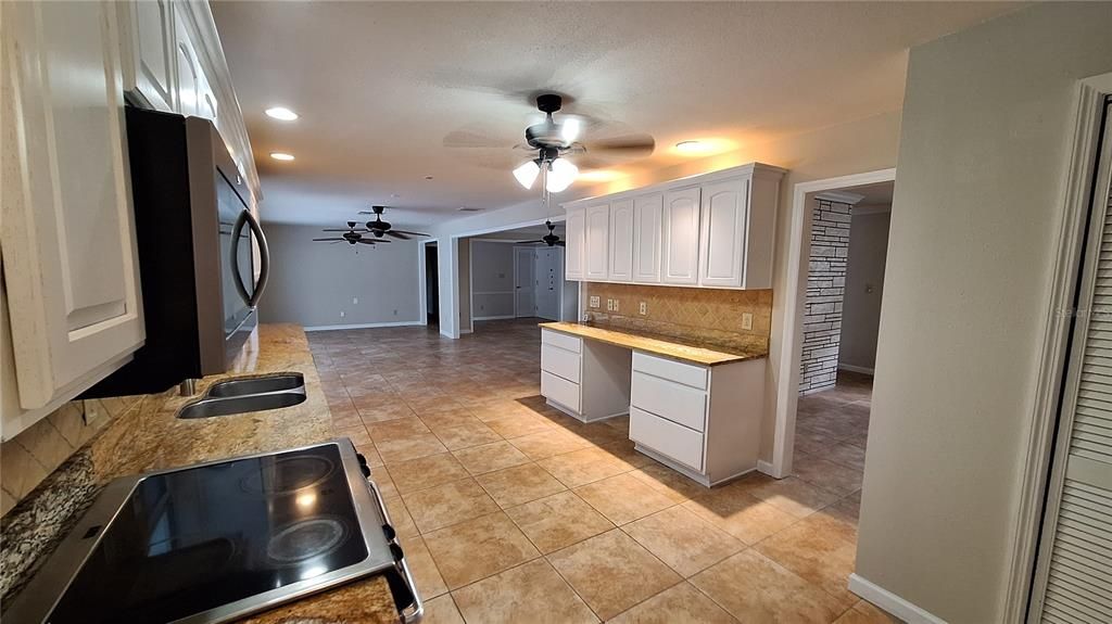 Kitchen with brand-new refrigerator and microwave.  Electric stove.