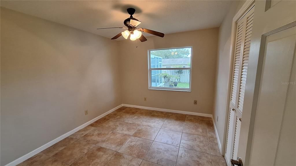 Bedroom 4 with ceiling fan and closet