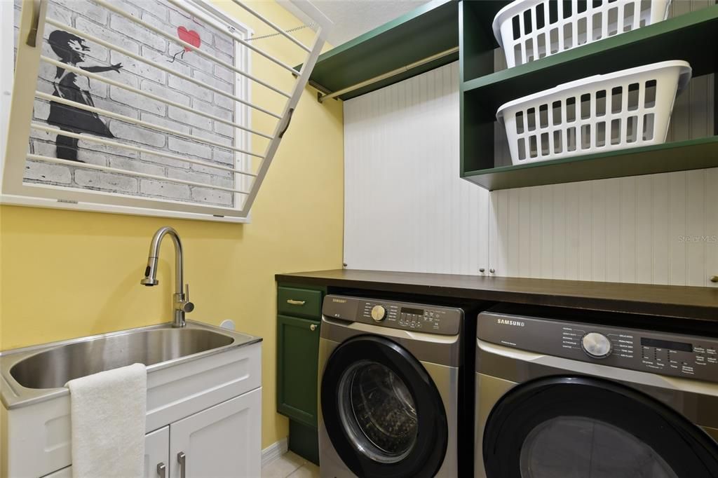 Laundry Room with built ins, folding table, drying rack and sink