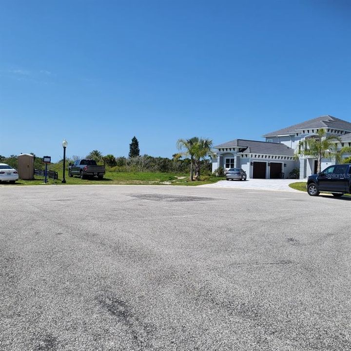 Empty lot located between two luxury homes.  Pie shaped.