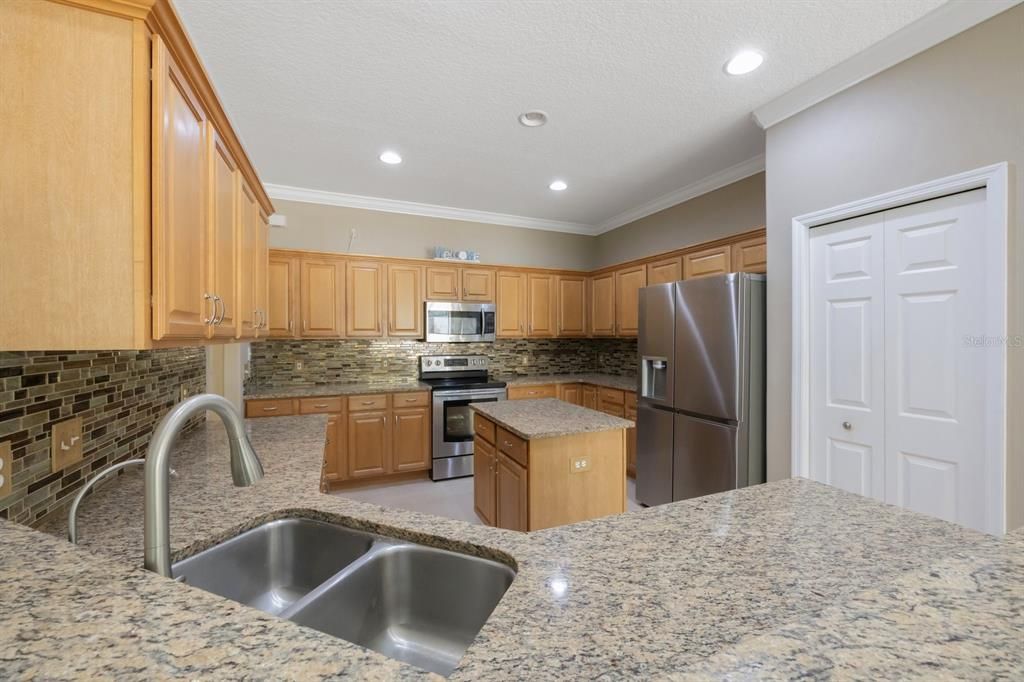 Kitchen with stainless appliances. New refrigerator and dishwasher