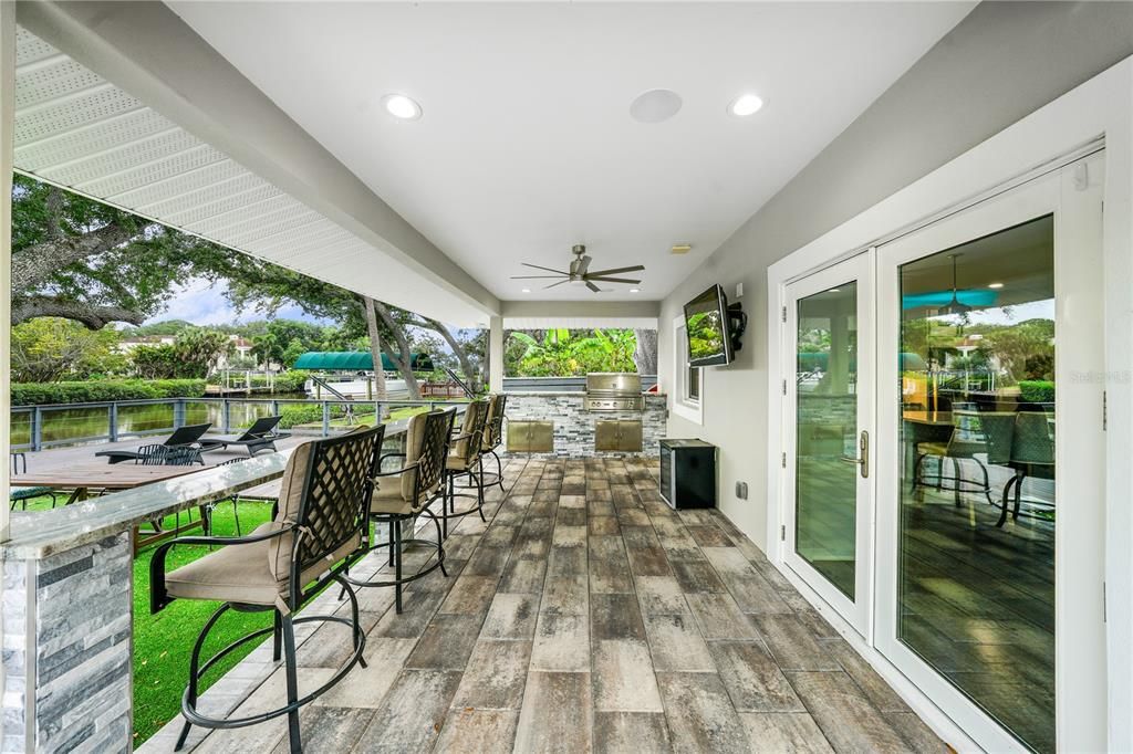 French doors off the kitchen open to the outdoor patio and grill