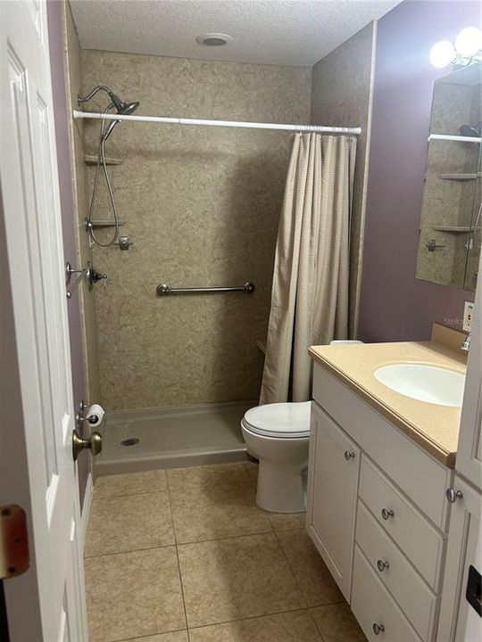 Remodeled bath with step in shower